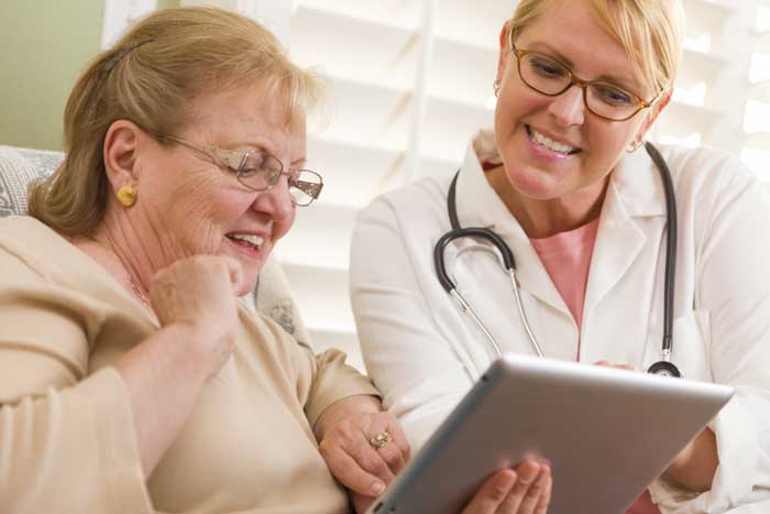 woman and nurse with tablet